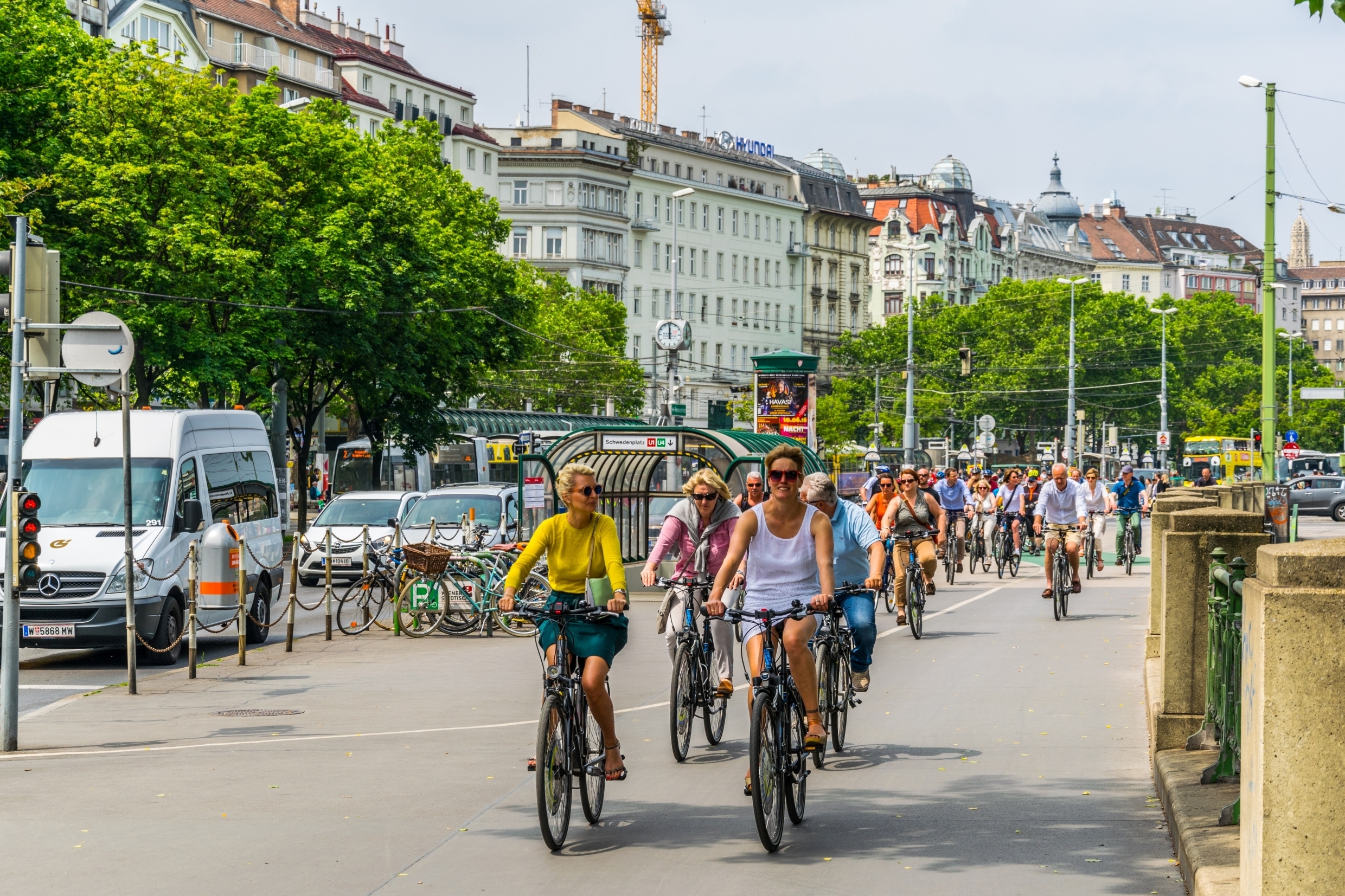 People are biking on a lane alongisde the donau channel in Vienna, Austria.
